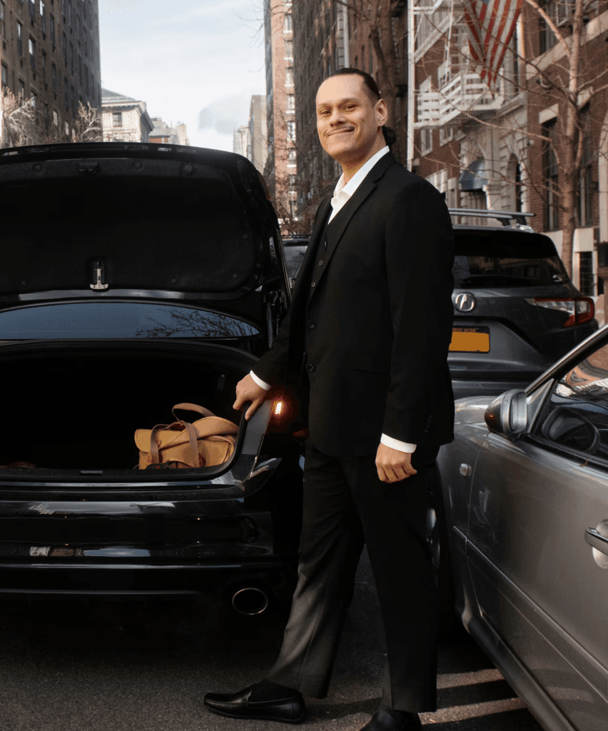 Professional chauffeur with luxury car